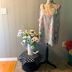 Sleeveless blouse. Beautiful Pastel flowers on a shaded pale blue background.